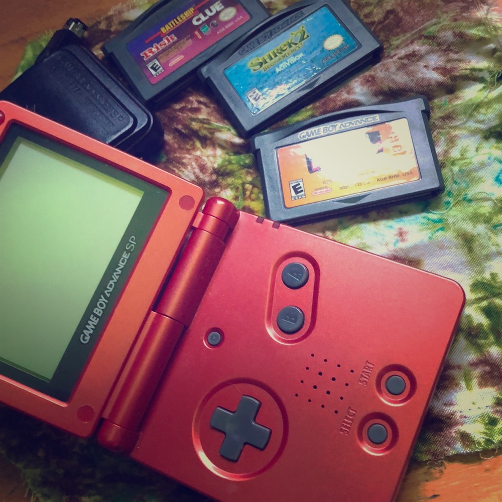 Game Boy Advance SP , includes 3 games & charger.